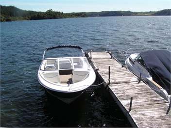 Ski and fishing boat at house jetty