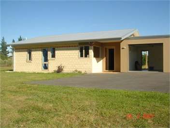 Front of Footrot Flat with roller garage door open