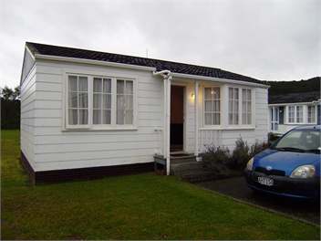 front of cottage on a rainy day