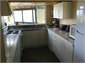 Kitchen looking out to covered seating in courtyd