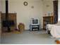 Lounge with log fire, TV, DVD and video player.