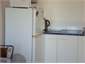 Fridge, microwave and sinkbench in kitchenette