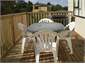 Table and chairs on deck with lake view