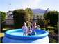 KIDS ENJOYING A SWIM IN BACK YARD