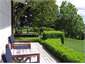 cottage deck overlooking farmland and river bank