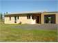 Front of Footrot Flat with roller garage door open