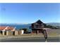 house from road to lake and mountains