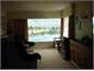 lounge with view over garden, lake and mountains