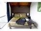 A luxurious upstairs queen bedroom with balcony.