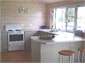 Fully equipped kitchen with bifold windows