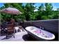 Private al fresco claw foot bath on cottage deck