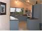 Kitchen, windows open on to deck