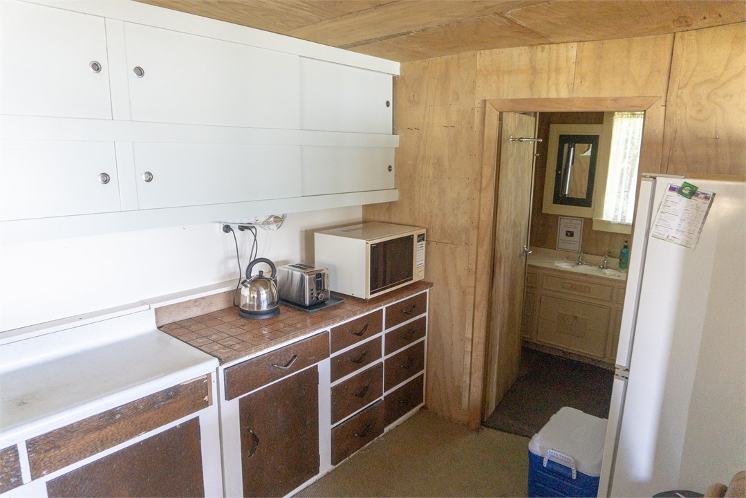 Section of kitchen leading into separate shower ro
