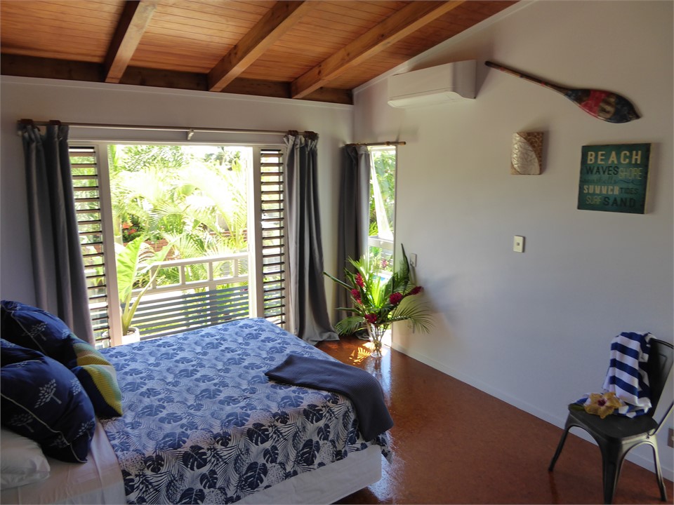 bedroom one has screened louvre windows, balcony