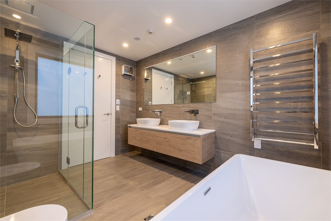 Bathroom 1 has a shower, bathtub and a toilet