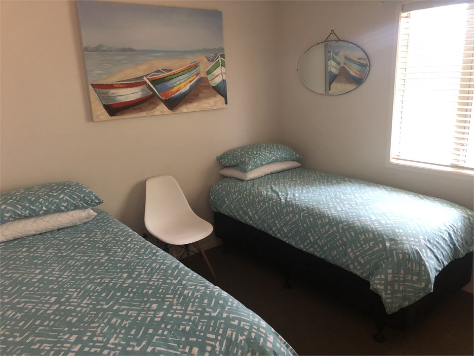 One bedroom has two standard single beds