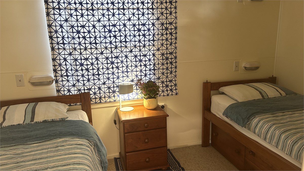 Two single beds downstairs in small bedroom