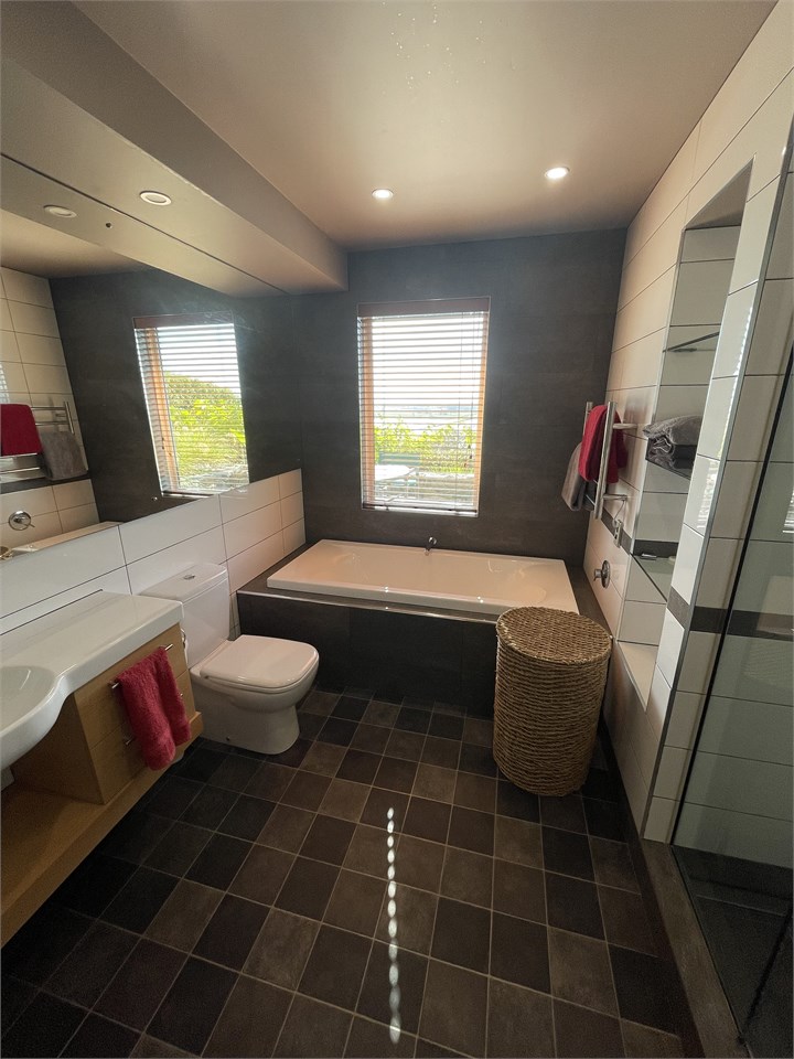 Bathroom, bath below window, shower to the right, 