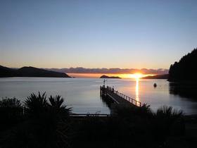 Sunrise over he wharf at Dryden Bay