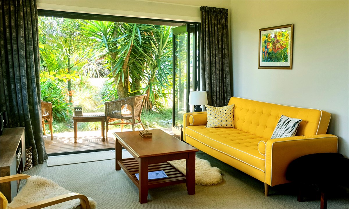 Living area looking out through double doors to ga