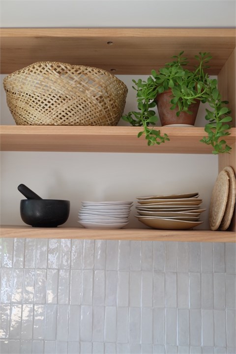 Well stocked kitchen shelves and cupboards.
