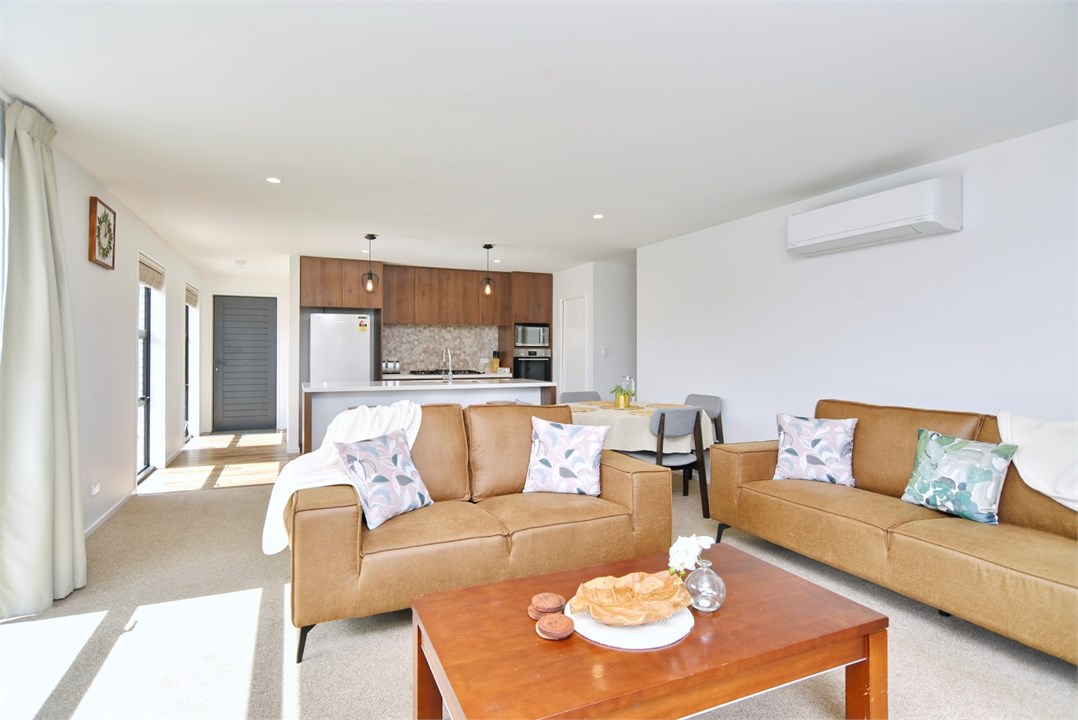 Living room has a TV and seating areas