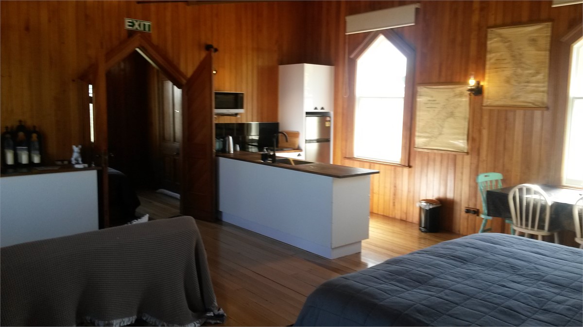 Single bed in entrance foyer behind double doors