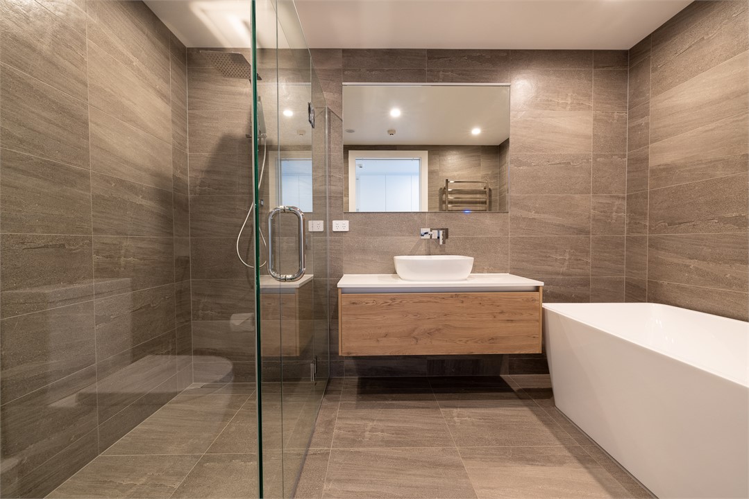 Bathroom 2 has a shower, bathtub and a toilet