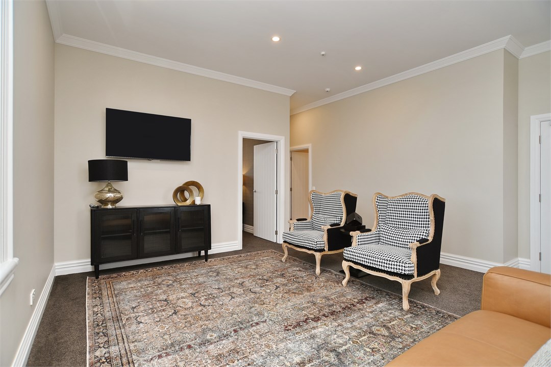 Living room with seating areas and a TV