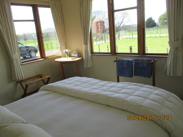 Main bedroom Queen bed with farm views