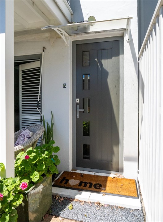 Charming front entrance with a soft French touch