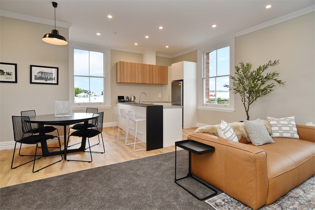 Living room with seating areas and a TV