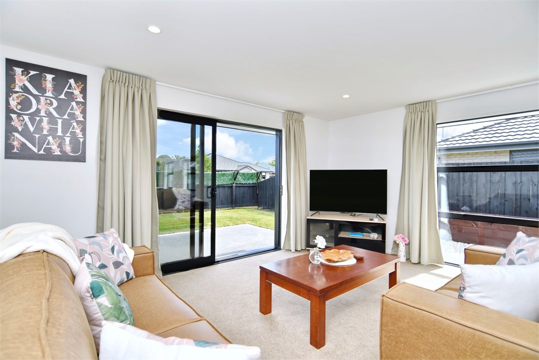 Living room has a TV and seating areas