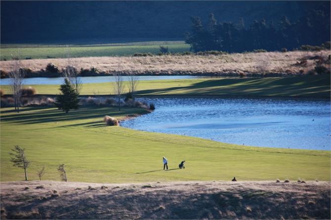 Golfers in the evening sun.