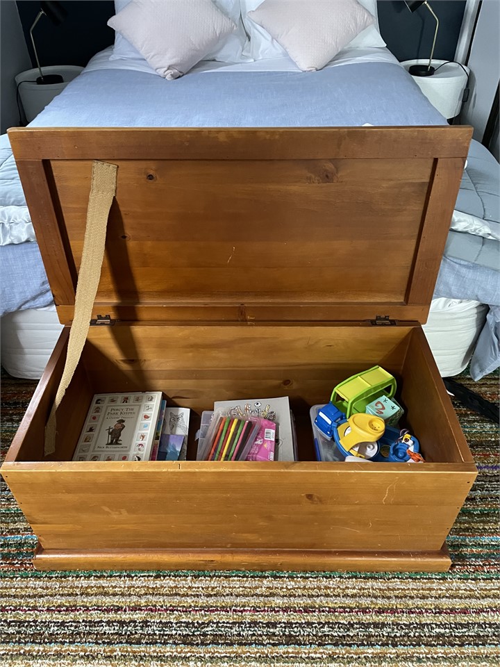 Children’s toys in blanket box in bedroom
