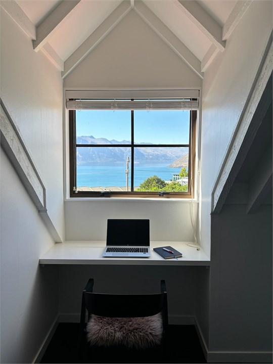 Bedrooms 2 and 3 both offer a desk area with lake