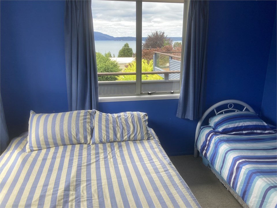 Upstairs front bedroom (Queen + single)