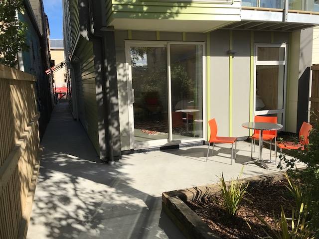 Sunny courtyard with alley to street