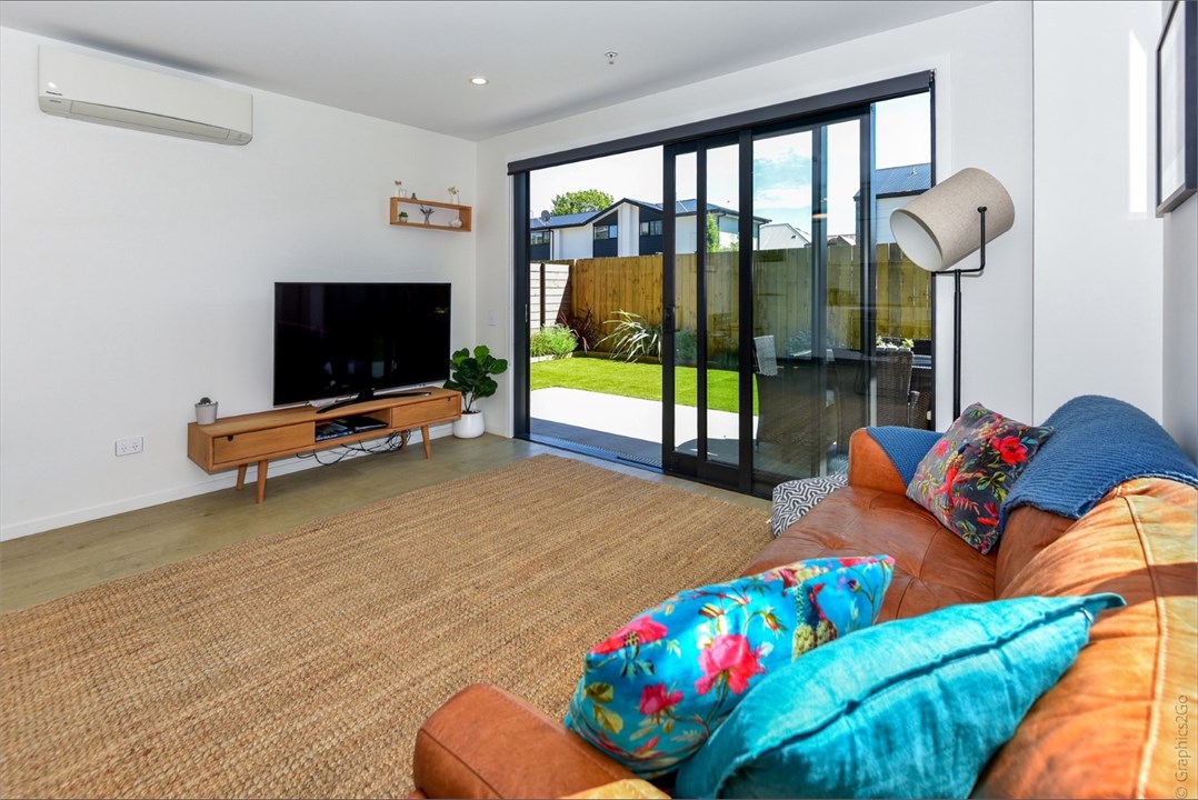 Living room has a TV and seating areas