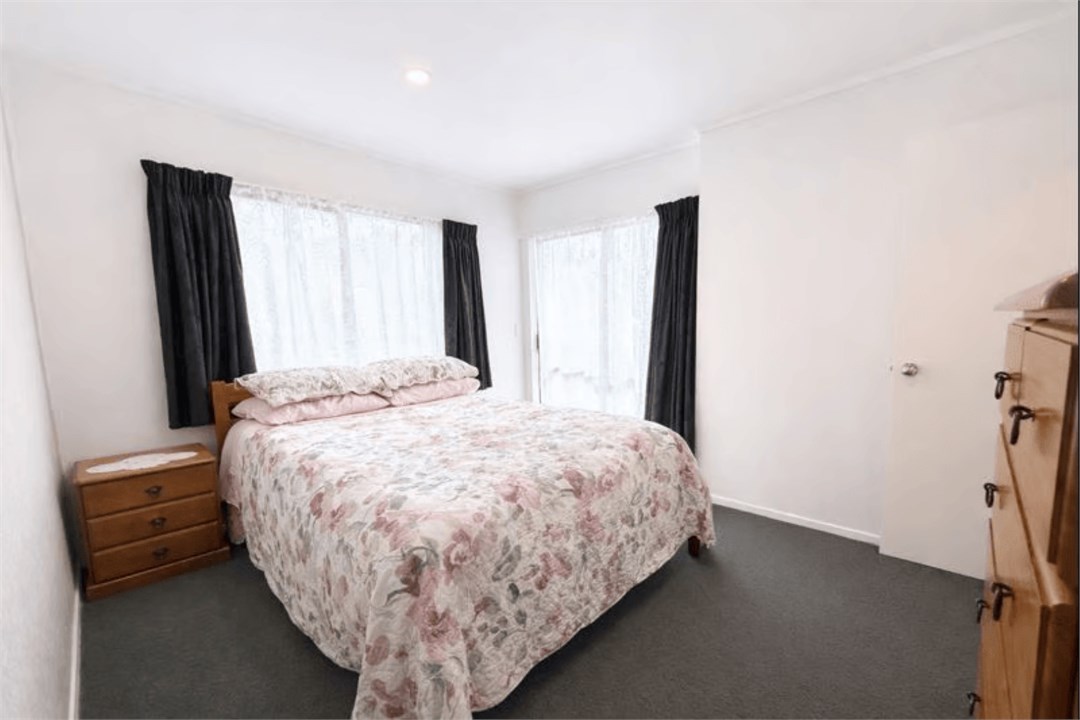 Sunny second bedroom with soft natural light