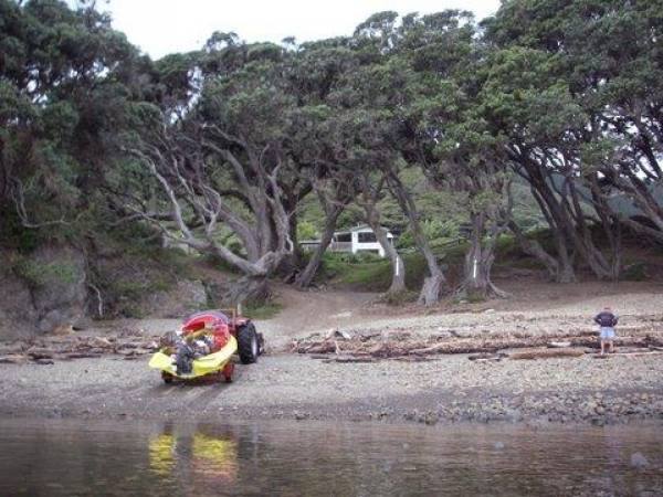 Boat launching with bach in background