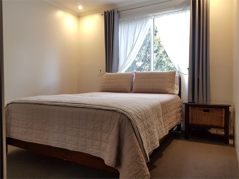 Queen Bedroom with A/C, Ceiling Fan and TV.