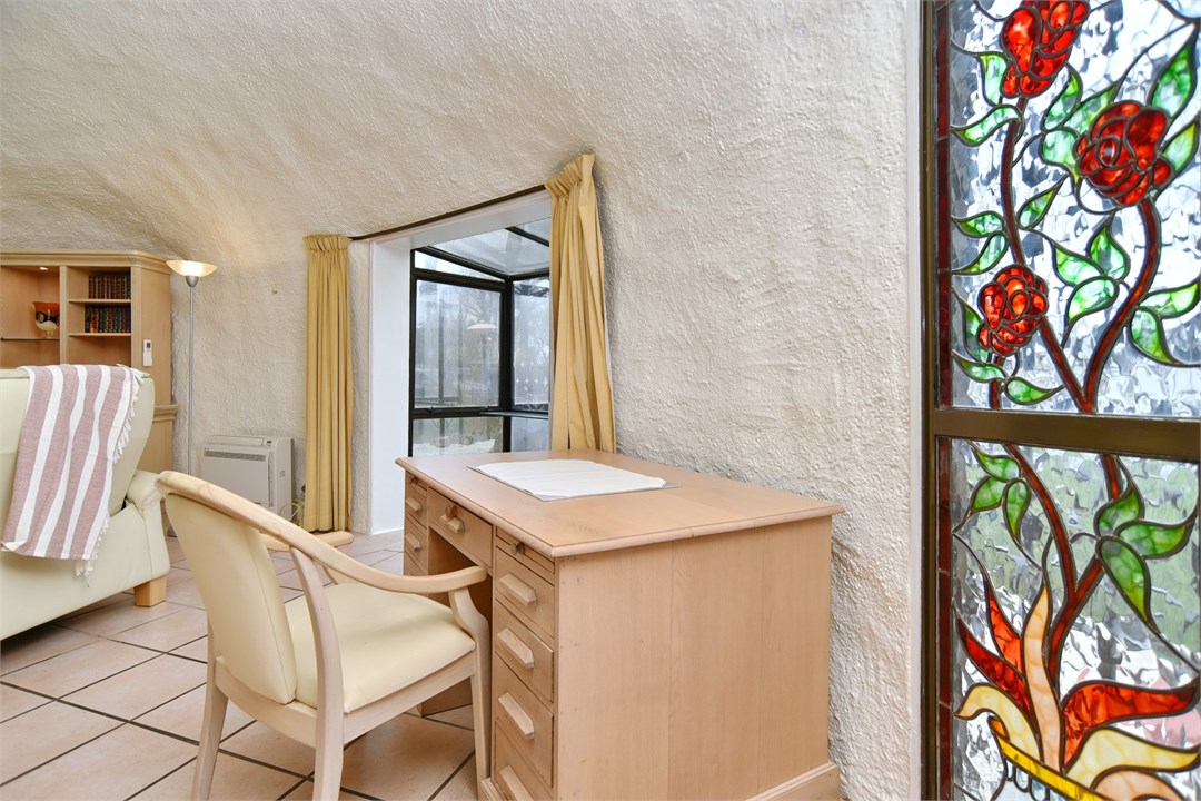 Living room with seating areas and a TV