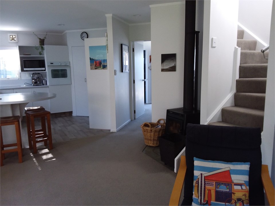 Upstairs to 1 queen bed and 2 single beds with adj