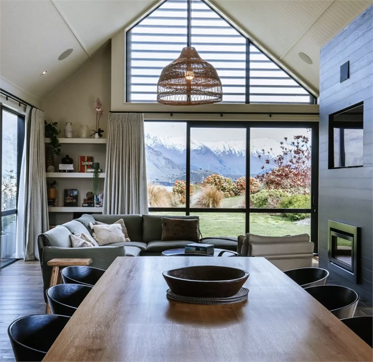 Dining and sitting room with lake and mountain vie