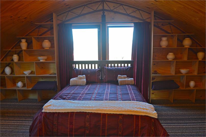 The upstairs bedoom has views over the hillsides.