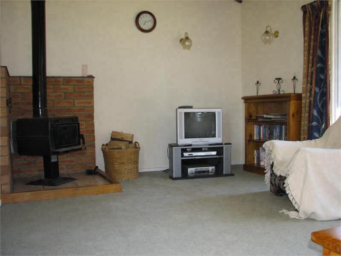 Lounge with log fire, TV and DVD player.
