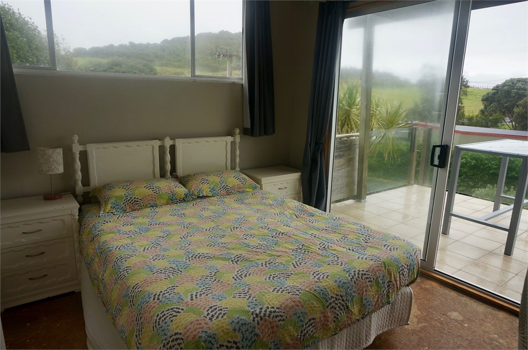 Upstairs master bedroom with doors to front deck
