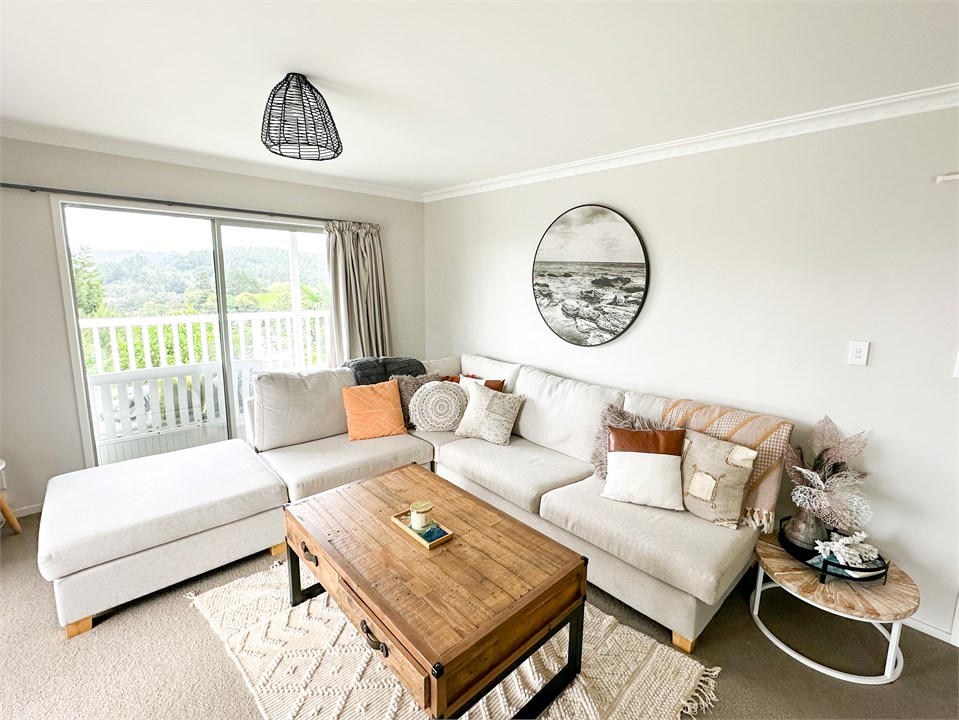 Spacious living room opens onto deck area.