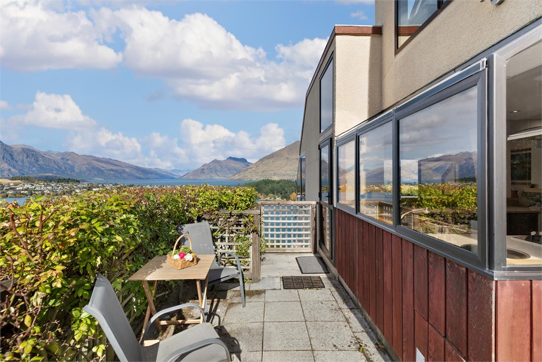 The side courtyard opens up to a public reserve